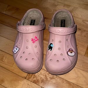 Pink fuzz crocs with jibbitz